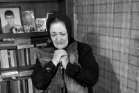 She is clutching the blood-soaked jeans of her son, killed by a Russian rocket attack on their house